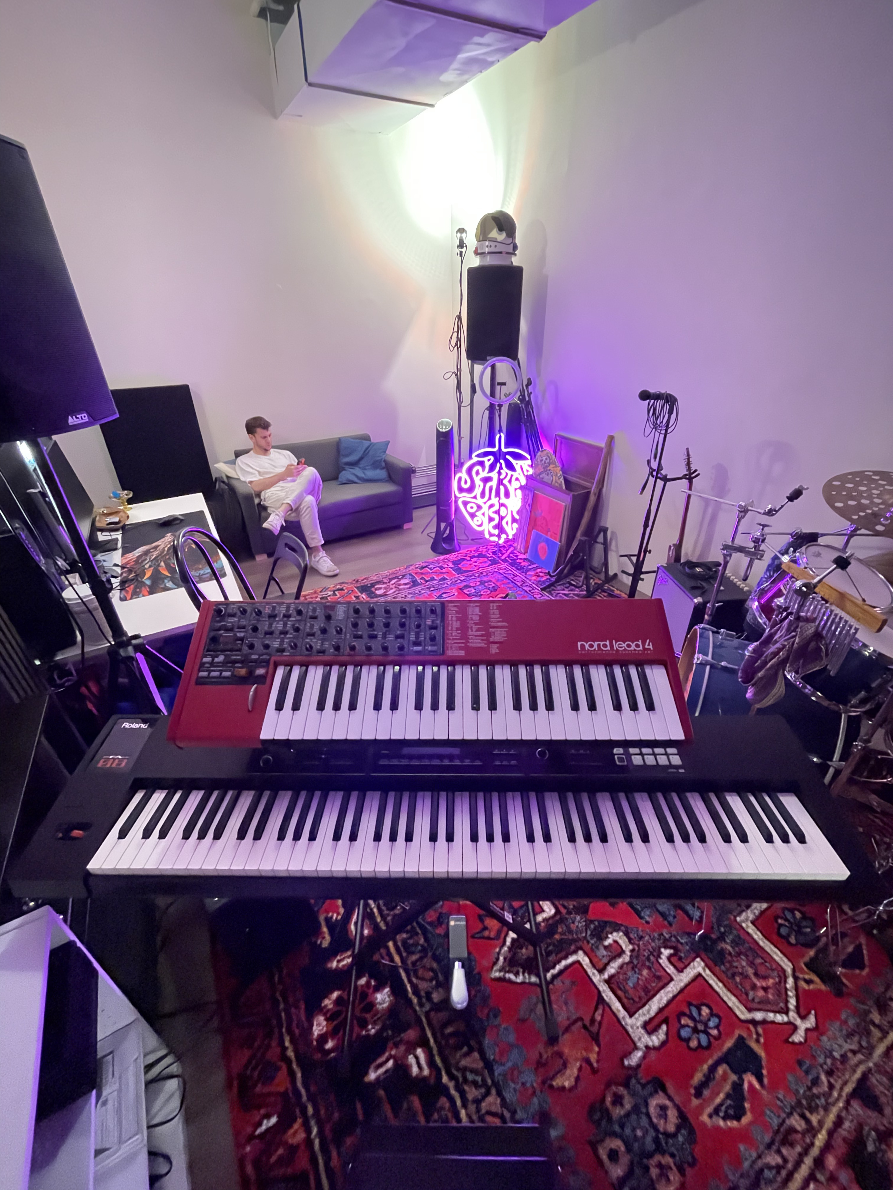 Guitar amplifiers arranged along studio wall